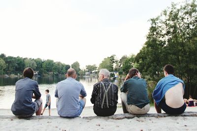 People relaxing on tree trunk