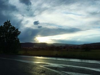 Road against cloudy sky at sunset