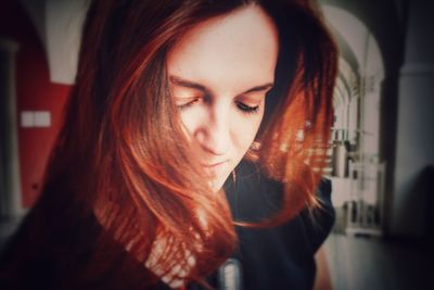 Close-up of woman with redhead in corridor