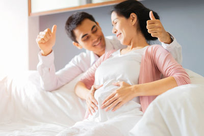 Young couple lying on bed at home