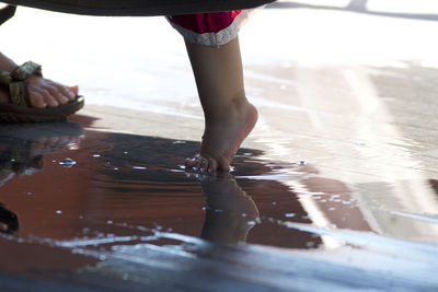 Full length of boy standing in water