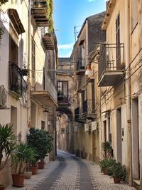 Narrow alley amidst buildings in city