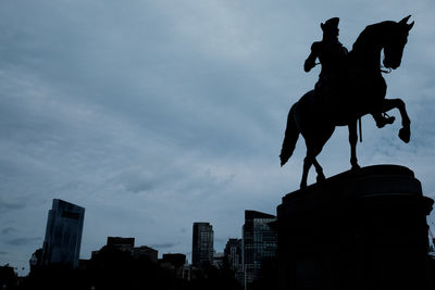 Low angle view of statue against cloudy sky