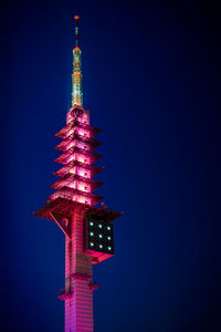 Low angle view of illuminated building against sky at night