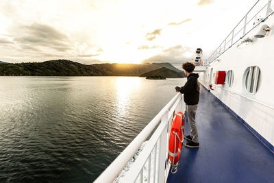 Teenager on boat traveling in between islands in new zealand