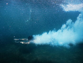 Young woman swimming in undersea