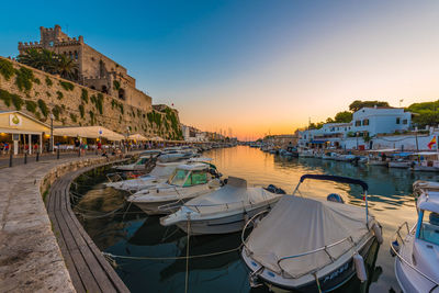 Panoramic view of sea and buildings against sky during sunset