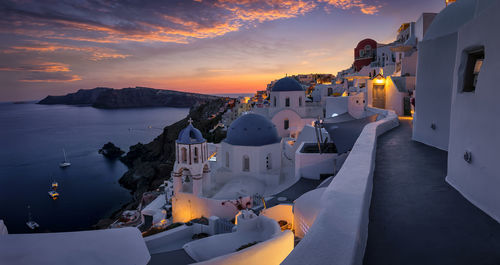 Panoramic view of buildings at seaside during sunset