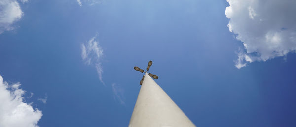 Low angle view of a sculpture against blue sky