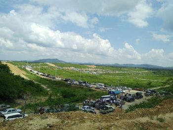 High angle view of cars on land against sky