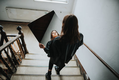 Woman standing on staircase