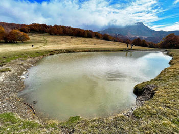 Cacciatore lake on prati di sara autumn foliage, italian appennino