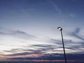 Low angle view of street light against cloudy sky
