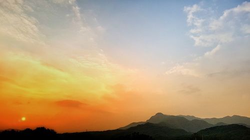 Scenic view of mountains against sky during sunset