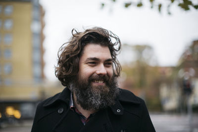 Bearded man smiling outdoors