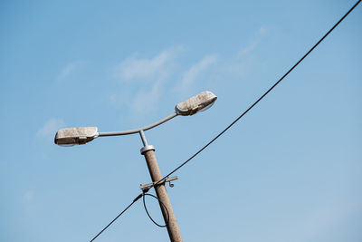 Low angle view of street light against sky