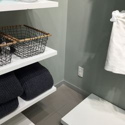 High angle view of basket and laundry in shelves at home