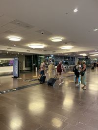 People in illuminated underground station