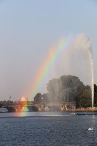 Scenic view of rainbow over river