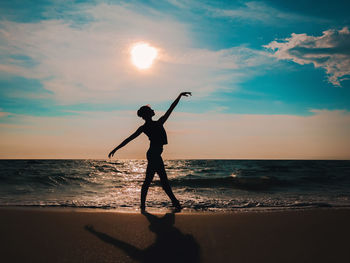 Woman ballet dancing at beach