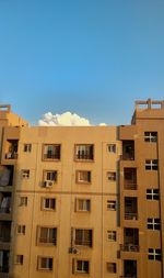 Low angle view of buildings against blue sky