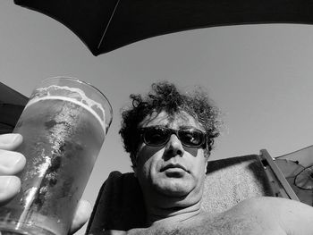 Portrait of man wearing sunglasses against sky