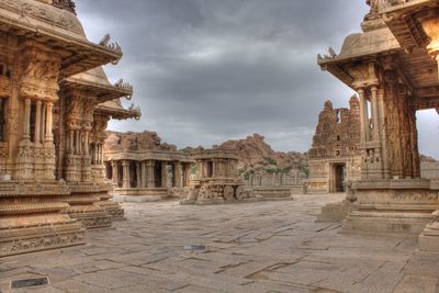 Historic temples against cloudy sky