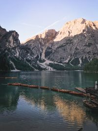 Scenic view of lake by mountains against sky