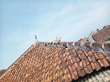 Low angle view of roof and building against sky