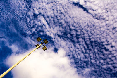 ;low angle view of floodlight against cloudy sky