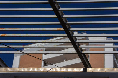 Low angle view of modern building against blue sky