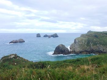 Scenic view of sea against cloudy sky