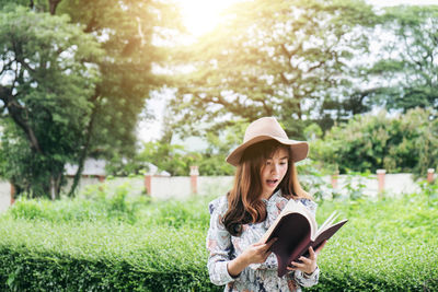 Woman wearing hat in park