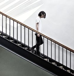 Full length of thoughtful man walking on steps