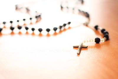 Close-up of rosary on table
