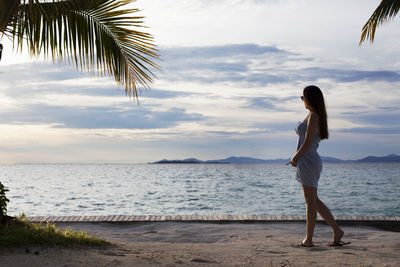 Full length of woman standing on beach