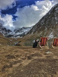 View of person on snowcapped mountains against sky