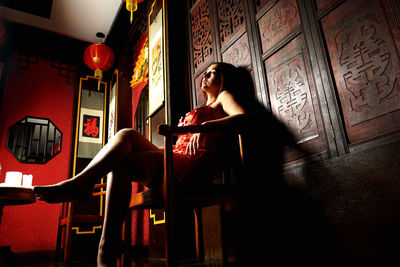 Woman sitting on chair at home