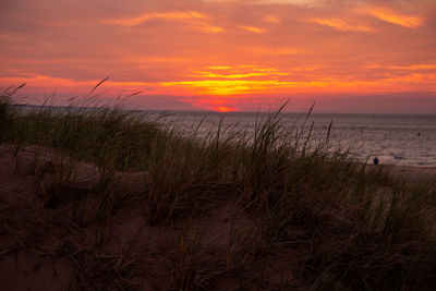 Scenic view of sea against romantic sky at sunset