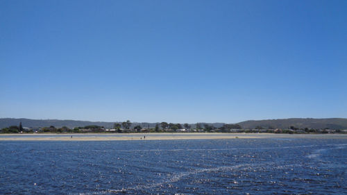 Scenic view of sea against clear blue sky