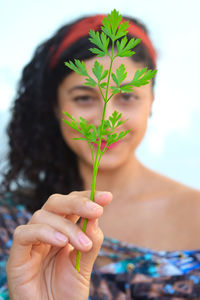 Close-up of woman holding plant