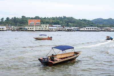 Boat moored on river against sky