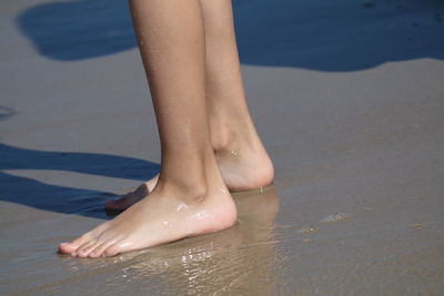 Low section of woman legs in water