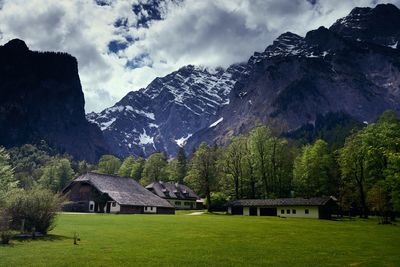 Houses on mountain against cloudy sky