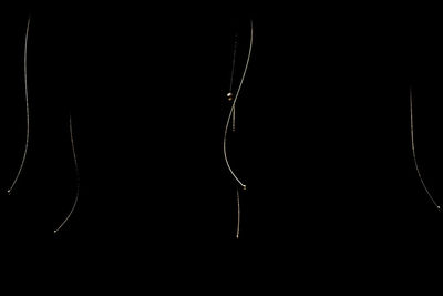 Close-up of silhouette metal against black background