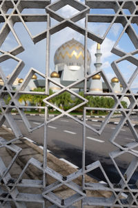 Full frame shot of metallic structure with fence in background