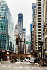 View of city street and buildings against sky