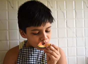 Portrait of boy eating food