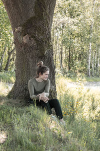 Young woman sitting on field