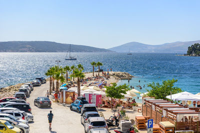 High angle view of townscape by sea against clear sky